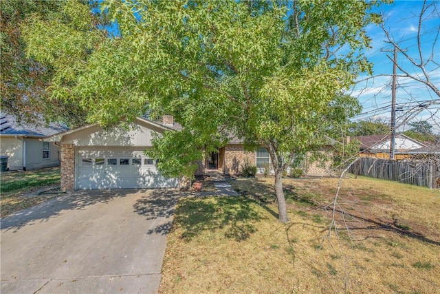 view of front of home featuring a garage and a front lawn