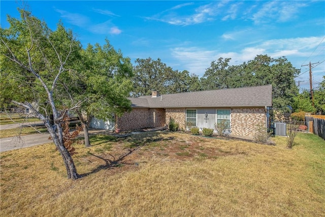 single story home featuring a front yard and central AC unit