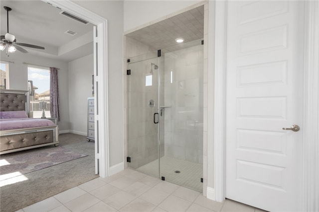 bathroom featuring tile patterned floors, ceiling fan, and a shower with door