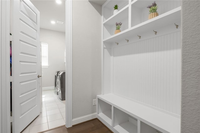 mudroom with tile patterned flooring and independent washer and dryer