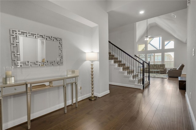 foyer entrance featuring ceiling fan, dark hardwood / wood-style flooring, and high vaulted ceiling