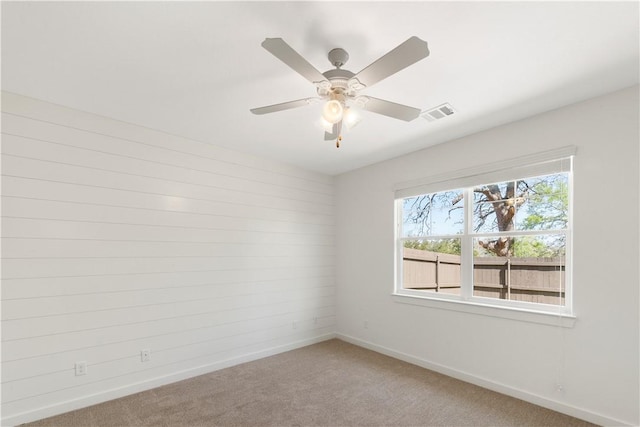 empty room with carpet and ceiling fan