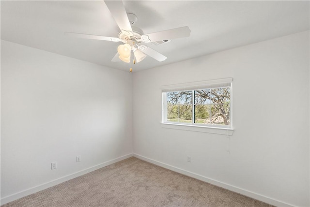 carpeted empty room featuring ceiling fan