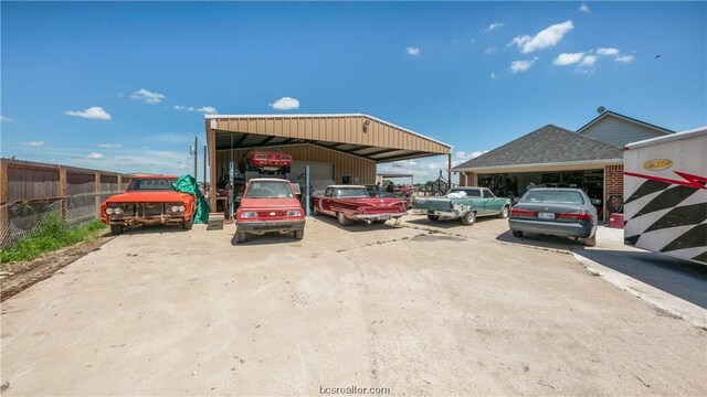 view of car parking featuring a carport and a garage