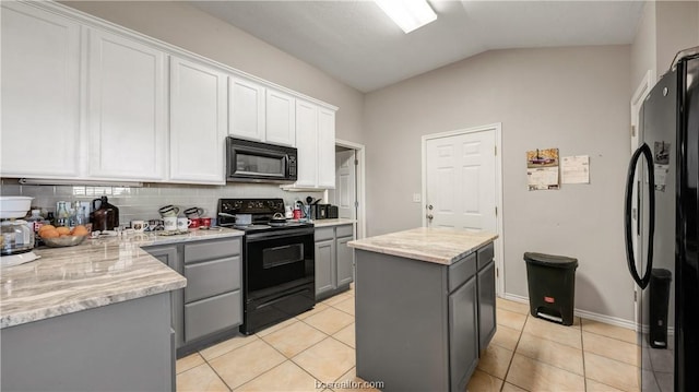 kitchen featuring gray cabinetry, lofted ceiling, black appliances, decorative backsplash, and white cabinetry