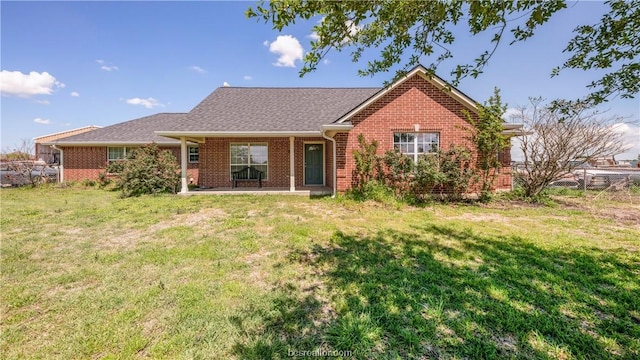 rear view of property with a lawn