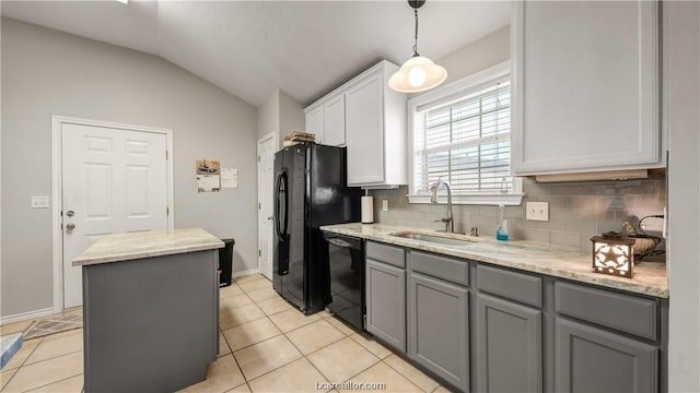 kitchen with lofted ceiling, black appliances, white cabinets, sink, and a kitchen island