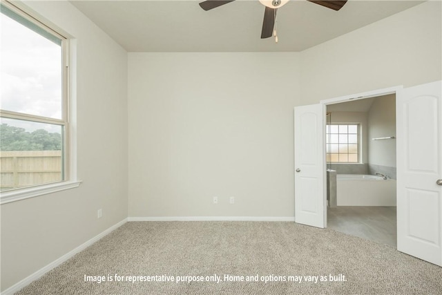 unfurnished bedroom featuring a ceiling fan, light carpet, and baseboards