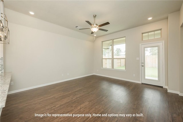 empty room featuring dark wood-style flooring, recessed lighting, visible vents, a ceiling fan, and baseboards