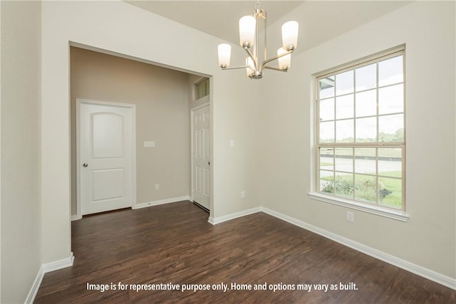 unfurnished dining area featuring dark wood-style floors, a chandelier, and baseboards