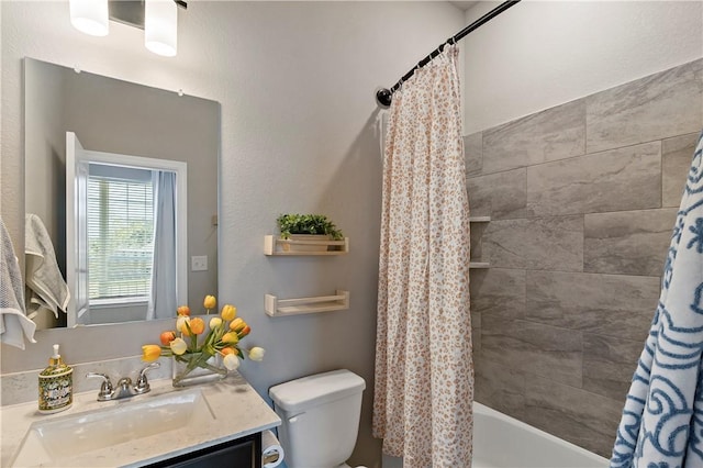 full bathroom with vanity, shower / bath combo, and toilet