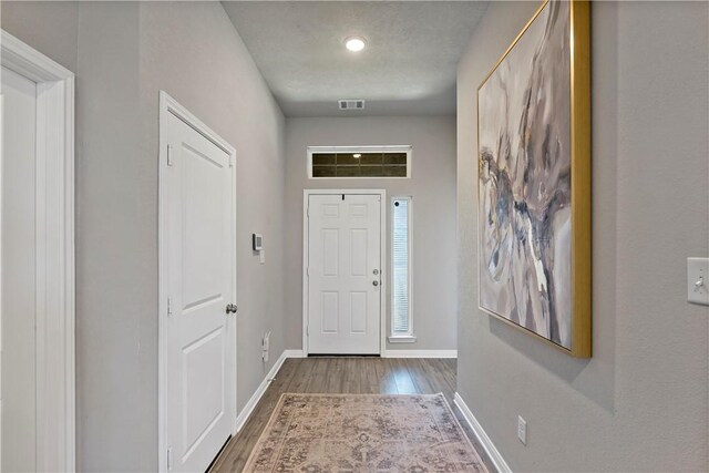 foyer entrance with dark hardwood / wood-style flooring