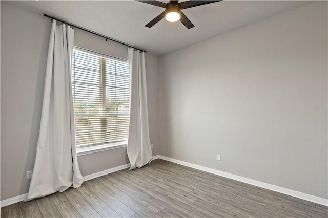 empty room featuring ceiling fan and light wood-type flooring