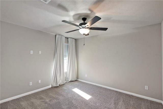 carpeted empty room featuring ceiling fan