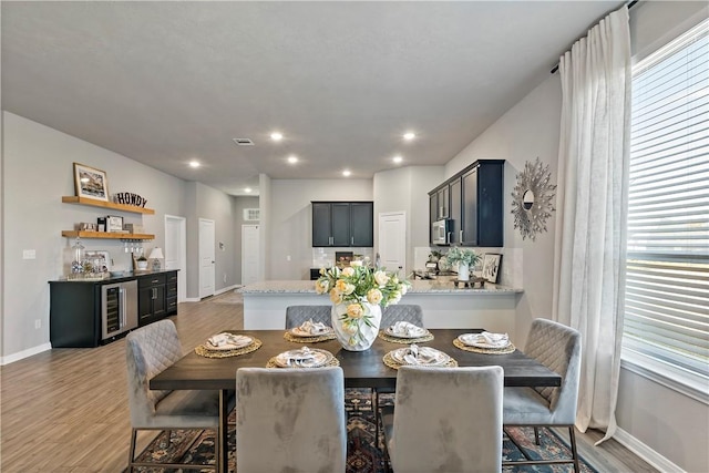 dining space with wine cooler and dark hardwood / wood-style flooring