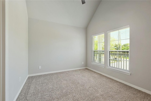 empty room with lofted ceiling, baseboards, and carpet flooring