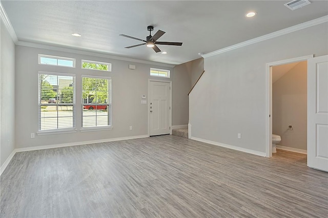 unfurnished living room with ornamental molding, visible vents, and light wood-style flooring