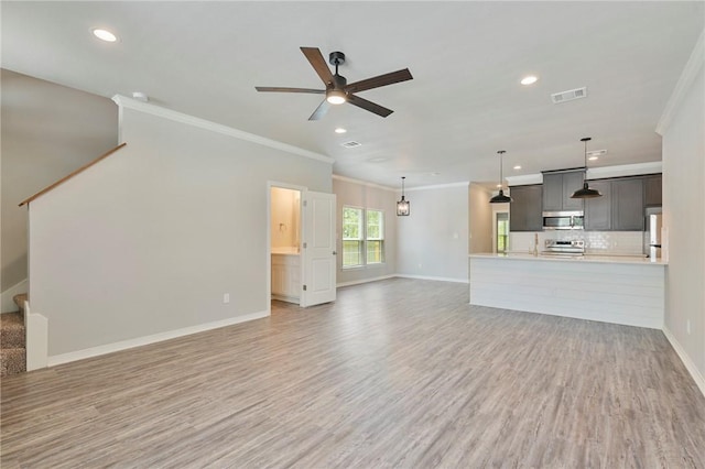 unfurnished living room with light wood-style floors, visible vents, stairway, and baseboards