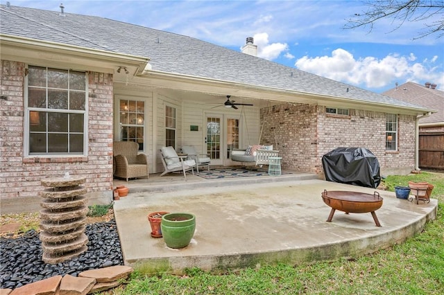 back of house featuring a shingled roof, a patio, brick siding, and ceiling fan