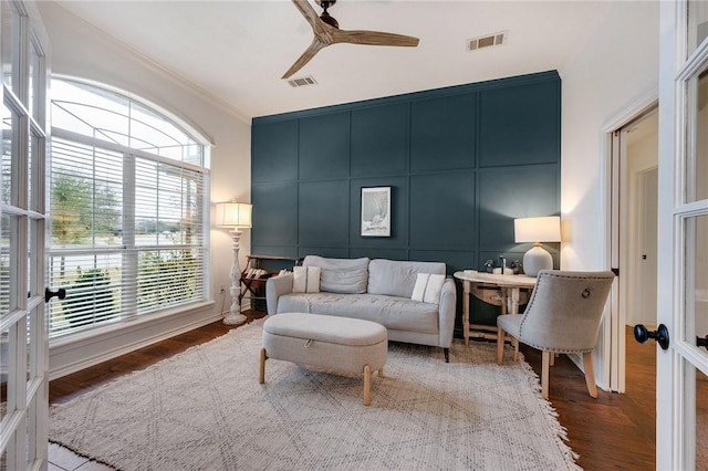 interior space featuring visible vents, wood finished floors, and a decorative wall