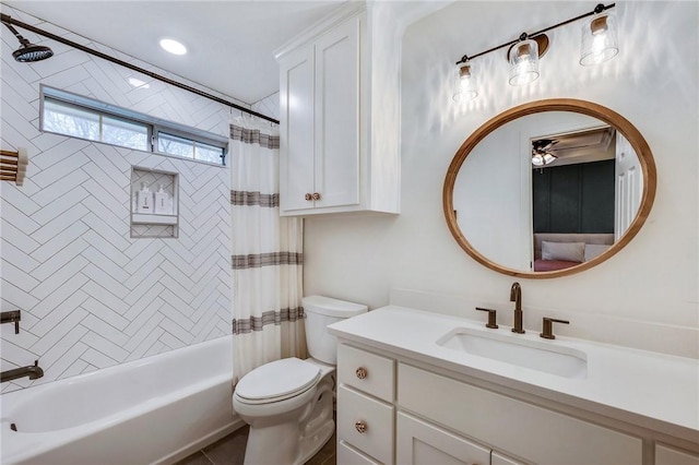 bathroom featuring vanity, shower / bath combination with curtain, and toilet