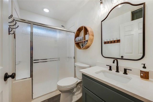 full bathroom with toilet, an enclosed shower, and vanity