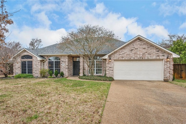 single story home featuring brick siding, a front lawn, an attached garage, and driveway