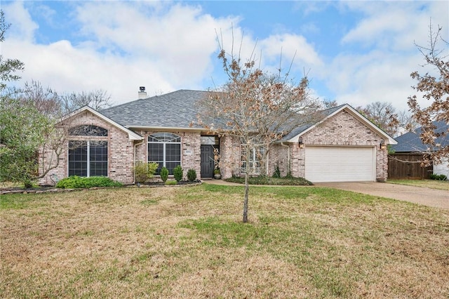 ranch-style home featuring brick siding, a front lawn, a chimney, a garage, and driveway