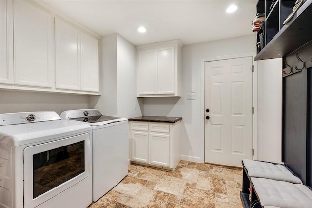 clothes washing area with baseboards, cabinet space, recessed lighting, separate washer and dryer, and stone finish floor