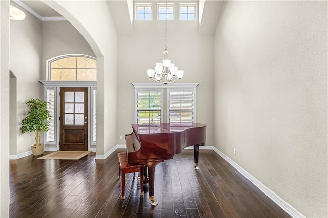 4507 Tonbridge Dr, College Station, TX 77845 - foyer entrance with arched walkways, a chandelier, a towering ceiling, plenty of natural light, and wood-type flooring