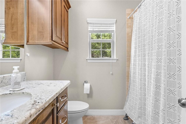 4507 Tonbridge Dr, College Station, TX 77845 - bathroom featuring vanity, toilet, baseboards, and plenty of natural light