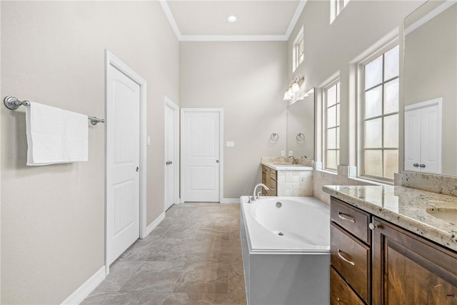 4507 Tonbridge Dr, College Station, TX 77845 - full bath featuring two vanities, baseboards, a garden tub, crown molding, and healthy amount of natural light