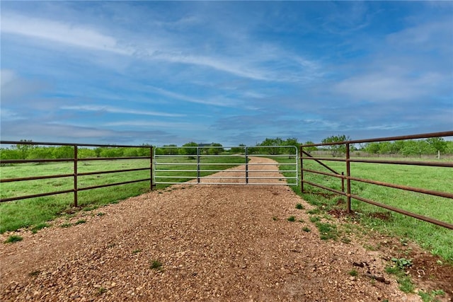exterior space with fence and a rural view