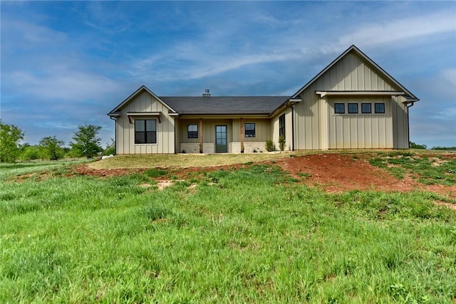 rear view of property featuring board and batten siding