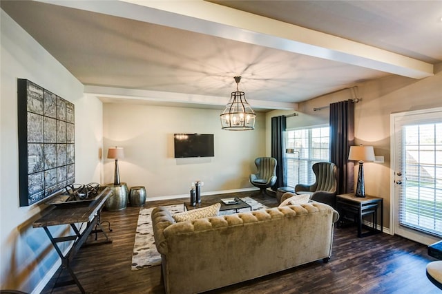 living area with a healthy amount of sunlight, dark wood finished floors, and beamed ceiling