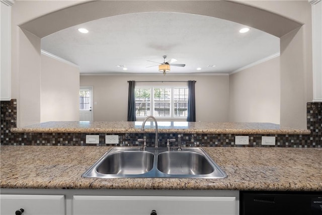 1403 Crescent Ridge Dr, College Station, TX 77845 - kitchen with dishwasher, arched walkways, crown molding, backsplash, and white cabinetry