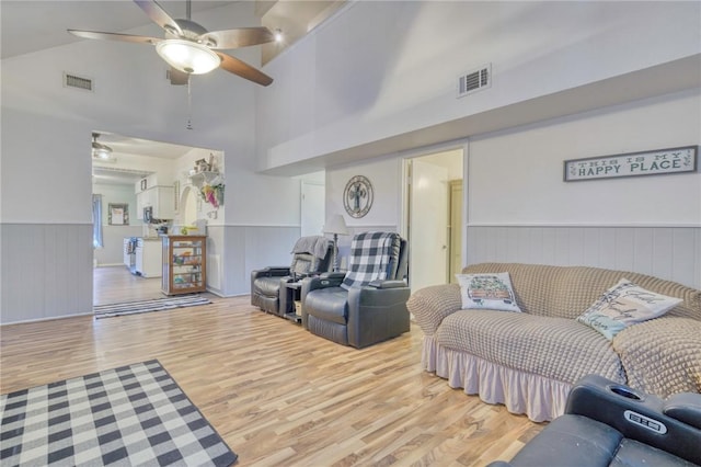 1681 Union Rd, Madisonville, TX 77864 - living area with wood finished floors, a wainscoted wall, a ceiling fan, and a towering ceiling
