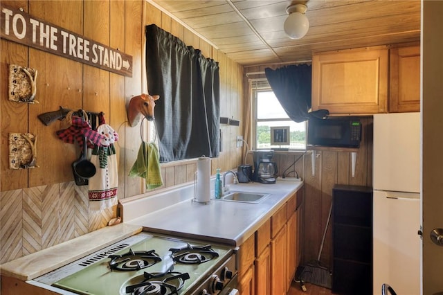 1681 Union Rd, Madisonville, TX 77864 - kitchen featuring black microwave, range with gas cooktop, a sink, brown cabinets, and light countertops