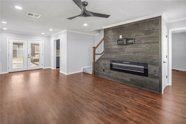 unfurnished living room with crown molding, dark wood-type flooring, ceiling fan, and french doors