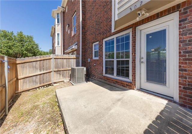 view of patio / terrace featuring fence and cooling unit