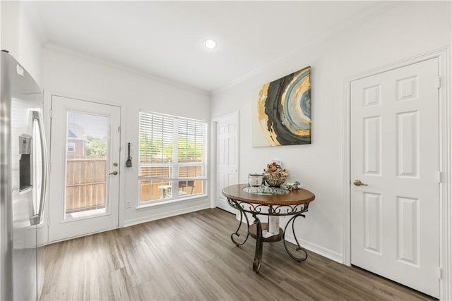 entryway featuring recessed lighting, baseboards, crown molding, and wood finished floors