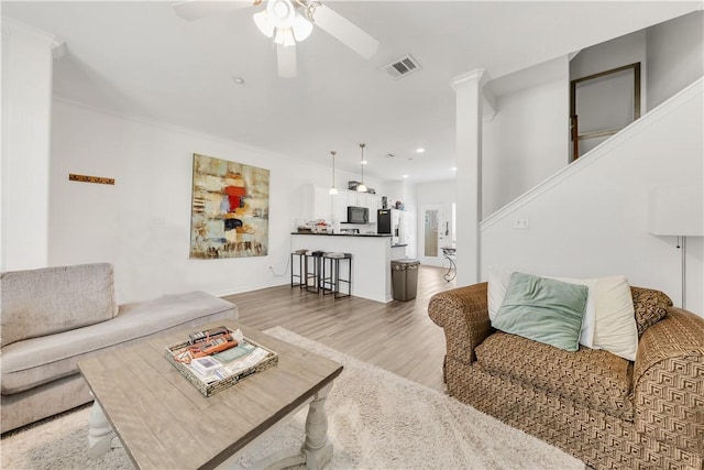 living area with visible vents, a ceiling fan, recessed lighting, stairs, and light wood-style flooring