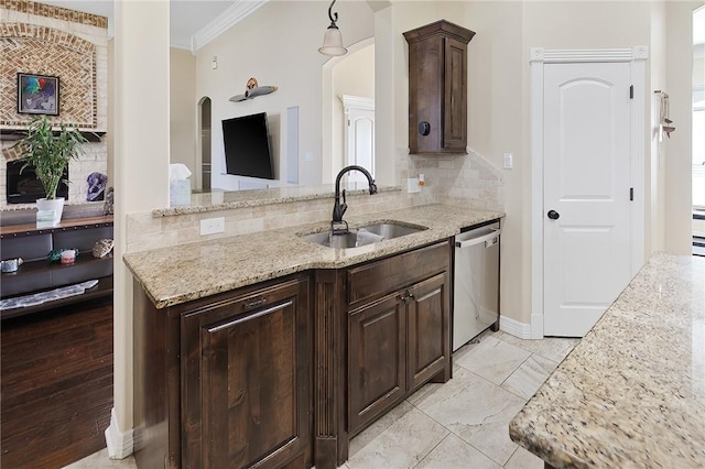 kitchen with light stone counters, a sink, ornamental molding, stainless steel dishwasher, and tasteful backsplash