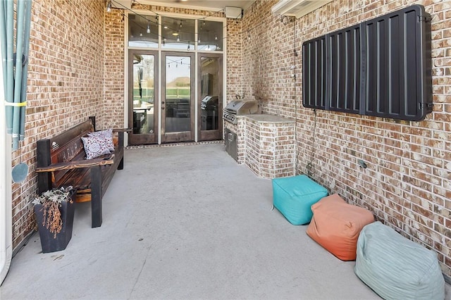 view of patio / terrace featuring exterior kitchen, french doors, and a grill