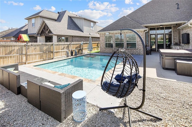 view of swimming pool with a hot tub, a fenced in pool, a fenced backyard, and a patio