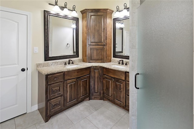 bathroom with double vanity, a sink, and tile patterned floors