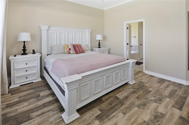 bedroom featuring ensuite bath, crown molding, baseboards, and wood finished floors