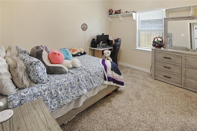 bedroom with baseboards and light colored carpet