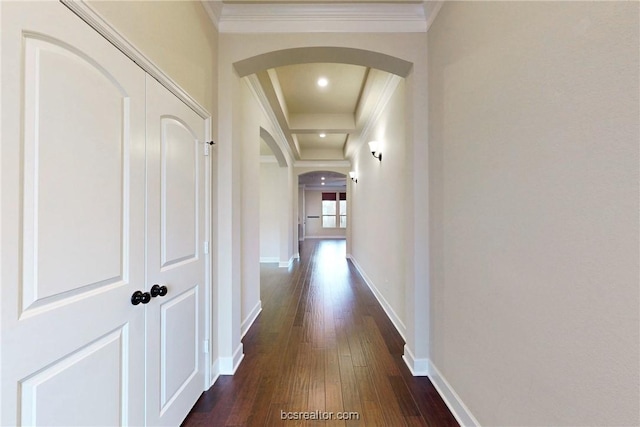 corridor with baseboards, arched walkways, dark wood-style flooring, and ornamental molding