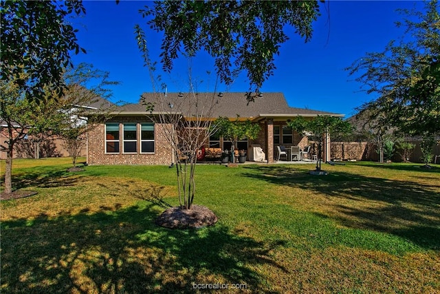 back of house featuring a yard and a patio area